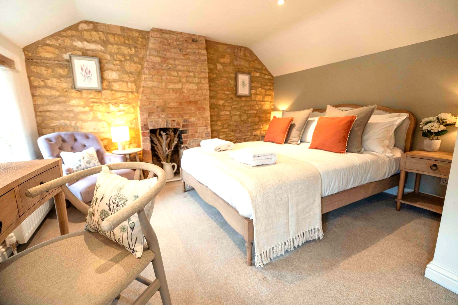 Double bedroom with an exposed Cotswold stone wall